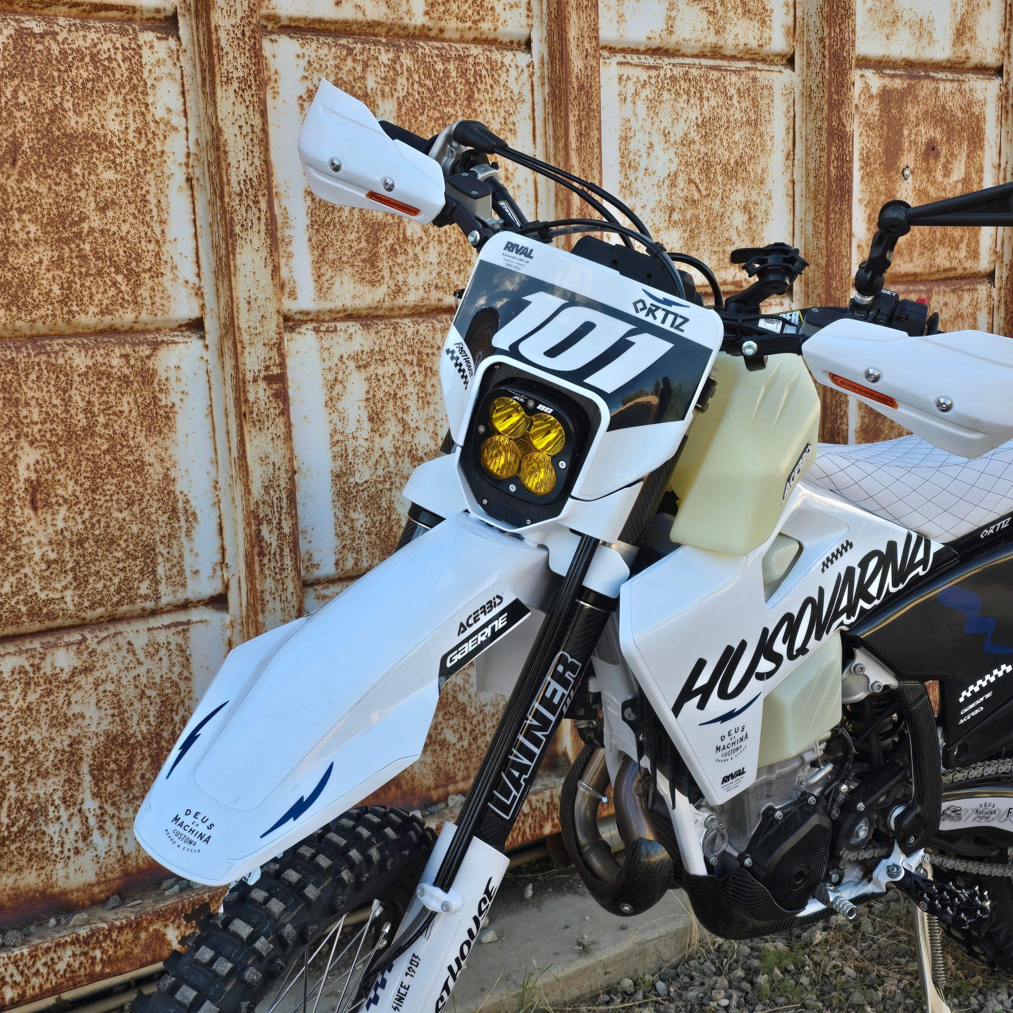 Husqvarna dirt bike with custom number plate and yellow headlight.