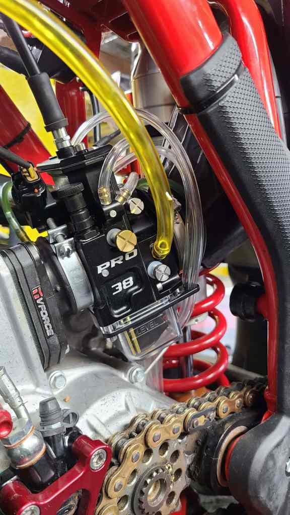 High-performance motorcycle engine with suspension components and chain drive.