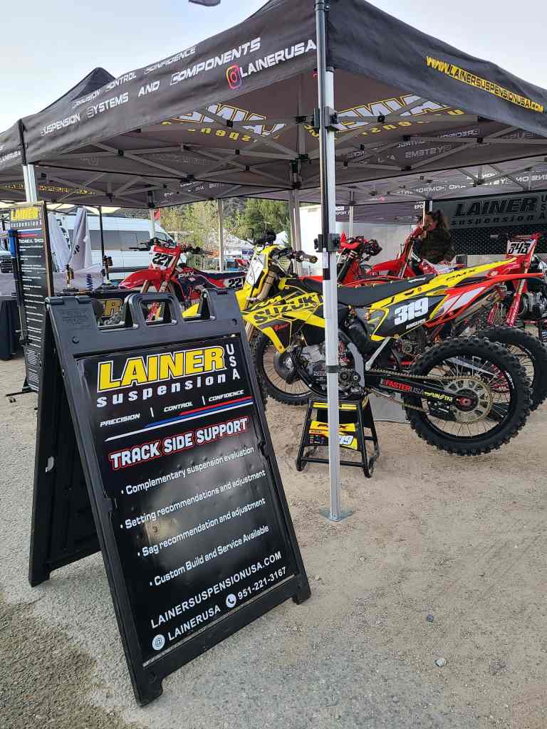 High-performance motocross suspension systems displayed at Lainer Suspension USA booth.