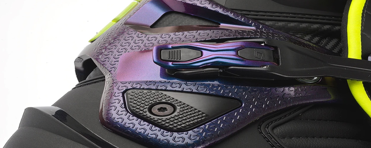 Close-up of ski binding with purple and black design and yellow accents.